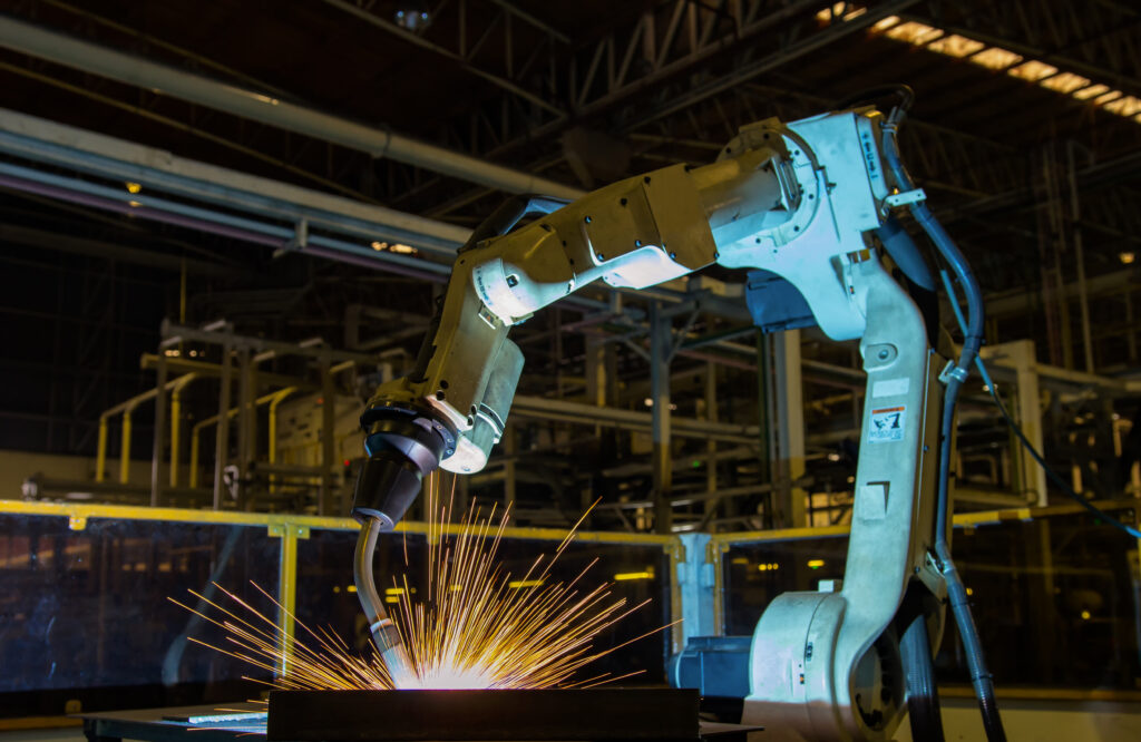 robot welds part in factory